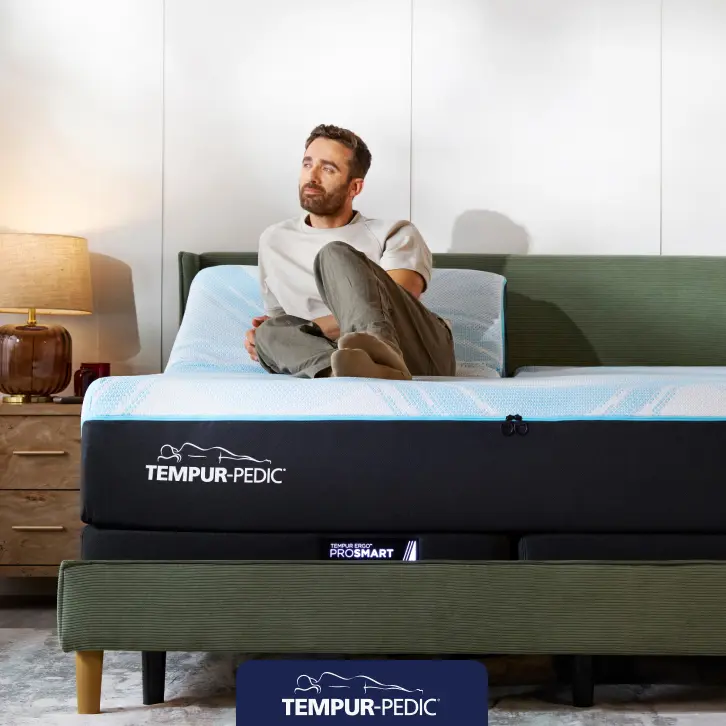 Tempur-Pedic adjustable mattress set displayed in a bright bedroom, highlighting savings of up to $300 instant gift.
