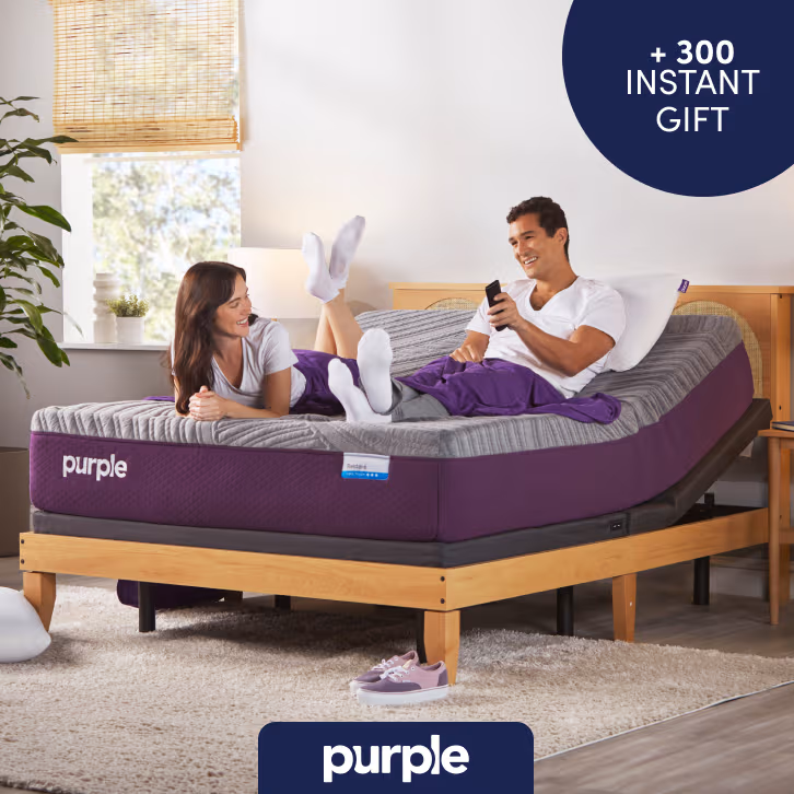 Couple laying on a Purple mattress with image badge that reads "+ $300 Instant Gift"