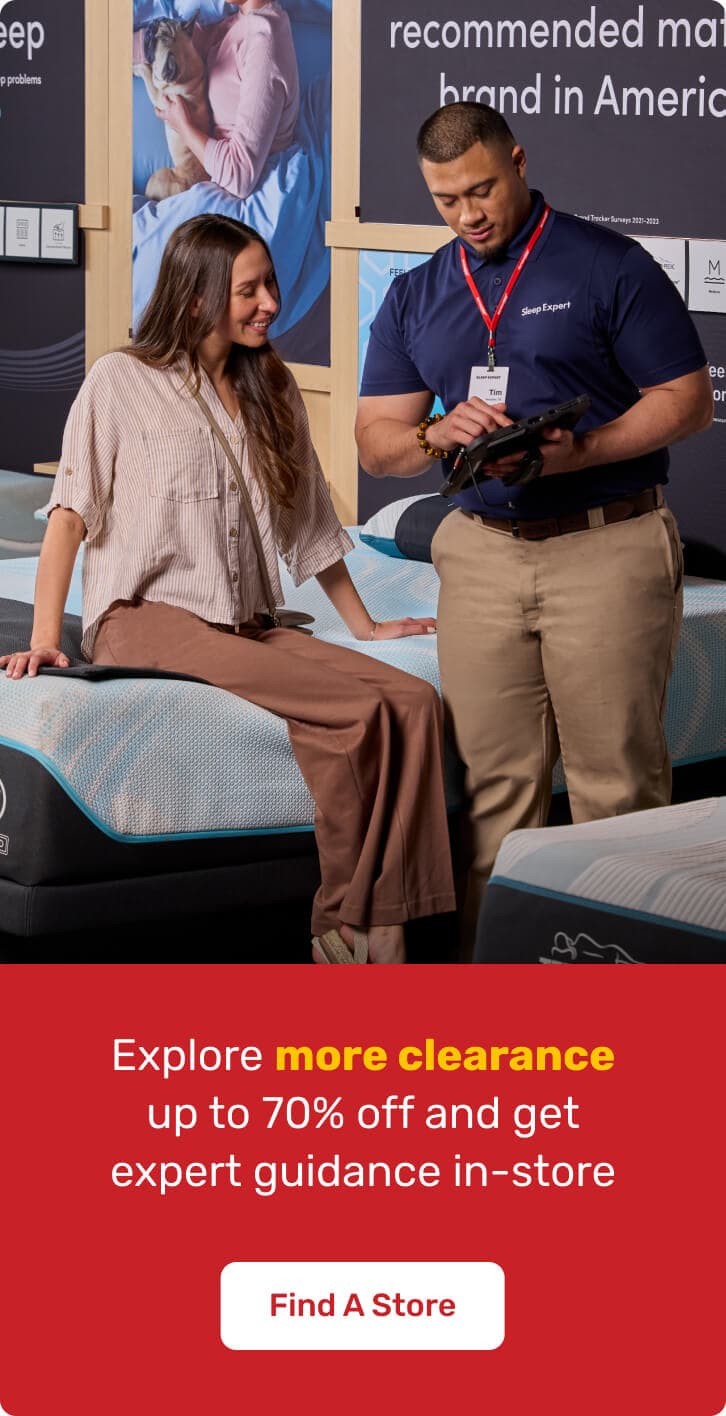 Mattress shopper consulting with a sleep expert in a mattress store while comparing mattresses and receiving guidance on sleep solutions.